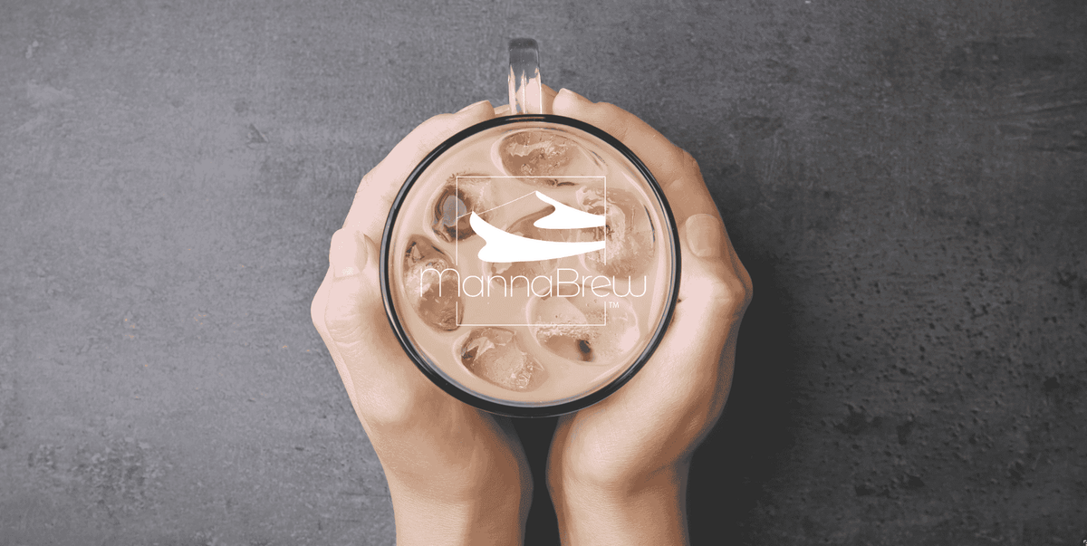 Hands holding a transparent mug with the mannabrew logo on a dark gray background